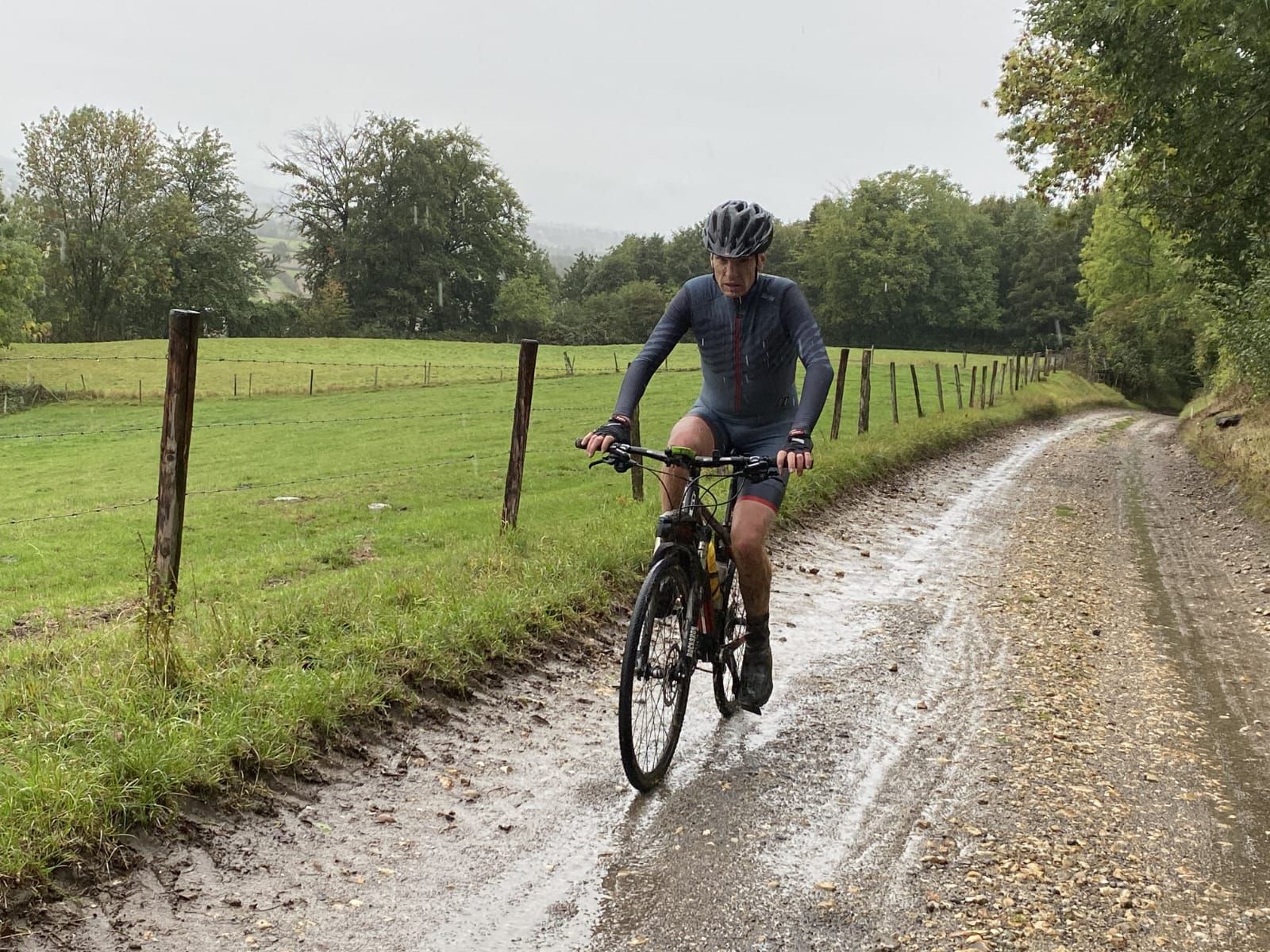 Cyclist Willem Oving riding along a muddy path